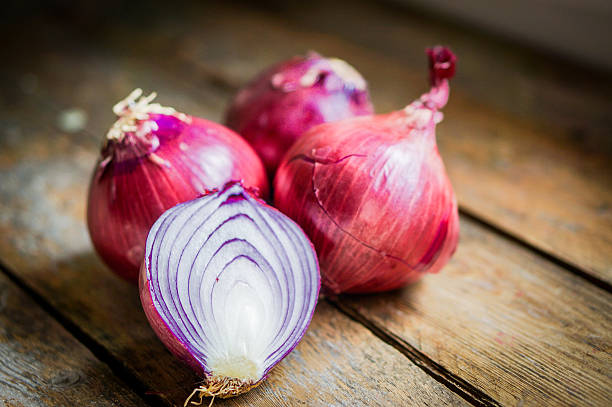 istock Red onions on rustic wooden background 466061061