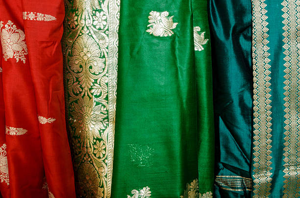Stylish Indian woman in silk saree and nose ring with OK gesture. Front pose