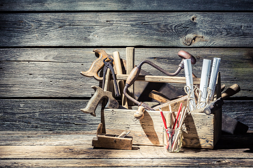 Vintage carpenter tools in a toolbox.