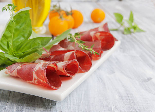 istock fresh beef cuts, carpaccio, with vegetables and basil 466062566