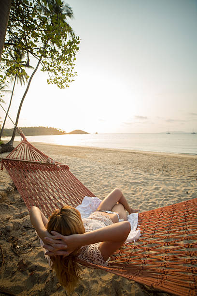 istock Woman enjoying sunset from hammock 466063202
