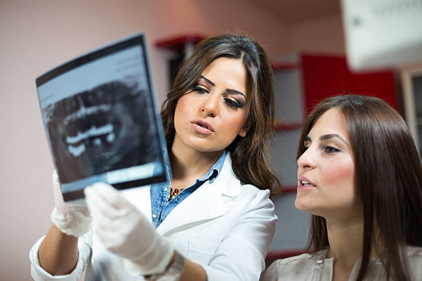 istock Dentist showing patient x-rays 466064058