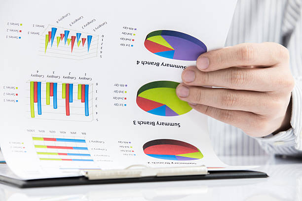 istock man hand with pen and business report 466064449