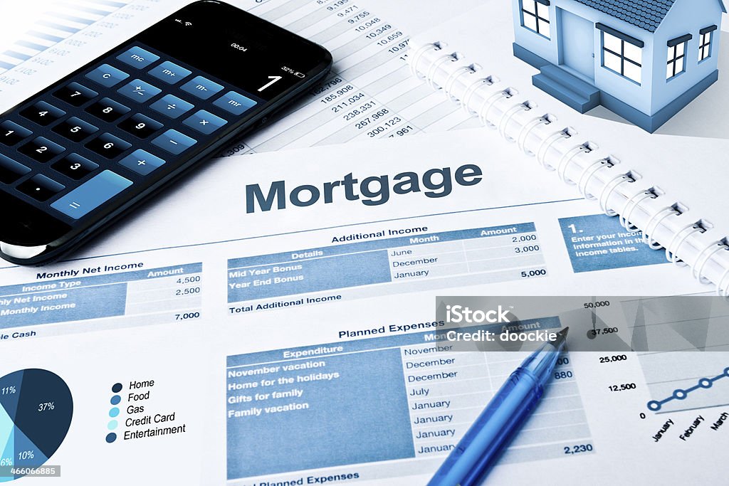 Mortgage Mortgage plan with calculator and pie charts Mortgage Loan Stock Photo