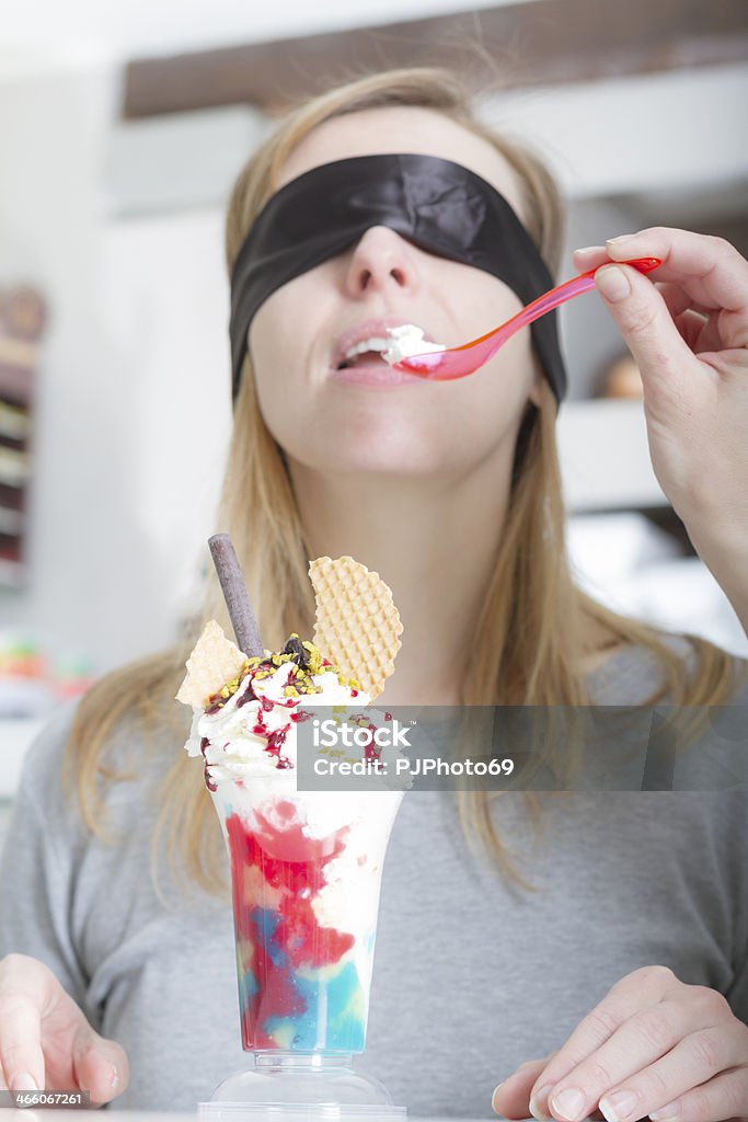 Blindfolded young woman tasting ice cream 20-29 Years Stock Photo