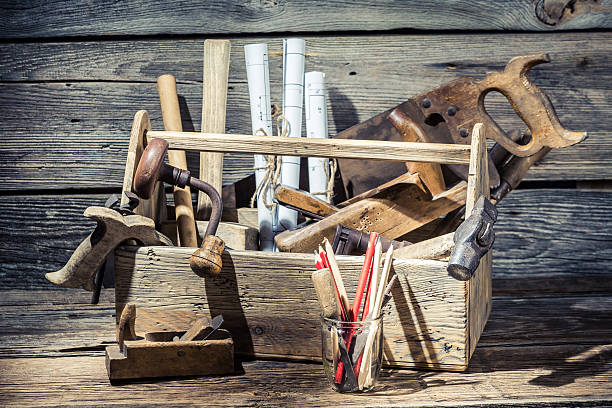 istock Hammer, saw and paper scheme in the carpentry workbench 466067276