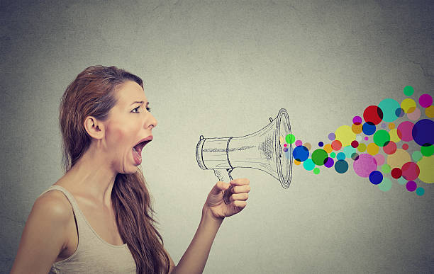istock Angry young woman screaming in megaphone 466067306