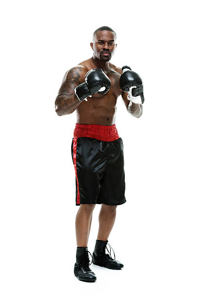 Muscular boxer looking at camera Muscular boxer looking at camerahttp://www.twodozendesign.info/i/1.png chest tattoo men stock pictures, royalty-free photos & images