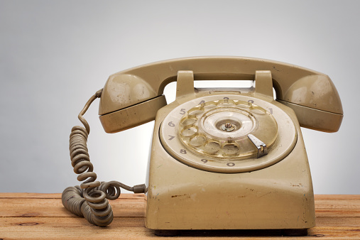 vintage telephone on wood background