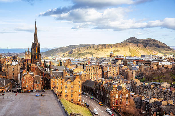 Looking Over Edinburgh Old Town To Arthurs Seat Looking over the buildings and roofs of Edinburgh Old Town to the cliffs of Salisbury Crags and the peak of Arthur's Seat. edinburgh scotland photos stock pictures, royalty-free photos & images