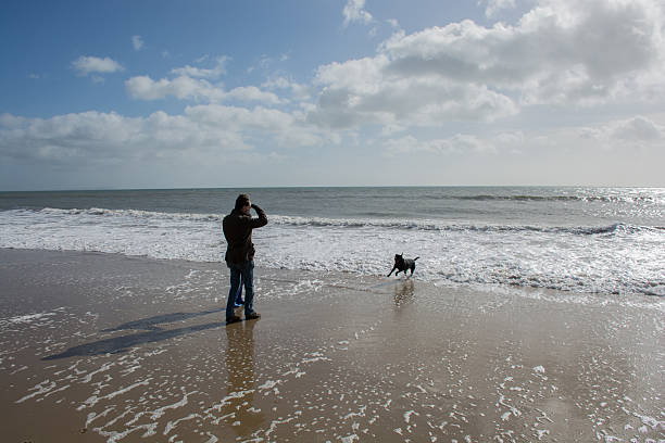 istock Couple by the water with dog 466072928