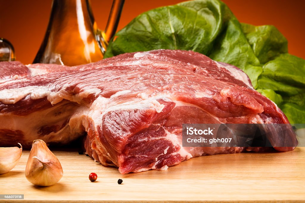 Raw pork with herbs and spices on a cutting board Fresh pork and vegetables 2015 Stock Photo