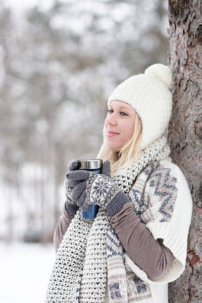 istock Happy girl with coffee in snowfall 466073153