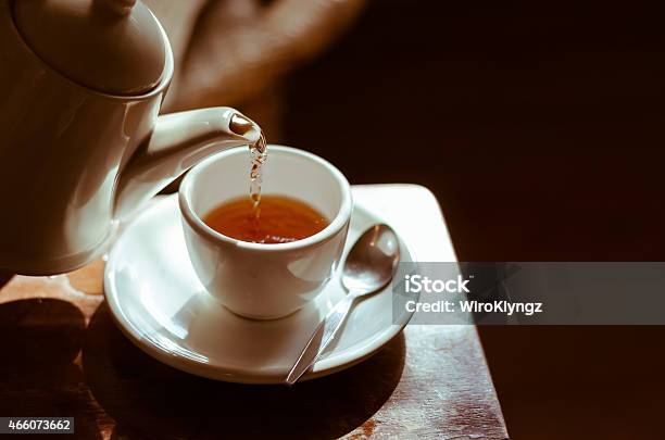 Tea Cup On Saucer With Tea Being Poured Stock Photo - Download Image Now - Tea - Hot Drink, Cup, Tea Cup