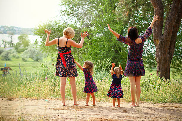 istock Two mothers with their daughters on the field in summer 466074773