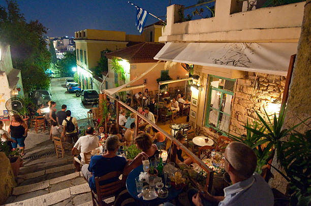 Street with various restaurants and bars on Plaka area, Athens. stock photo