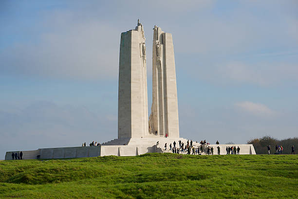 Visitors to the Canadian War Memorial, Vimy Ridge. France Vimy, France - November 11, 2014: Visitors around the Canadian War Memorial after the Remembrance Day service at Vimy Ridge. The memorial was designed by Walter Seymour Allward and unveiled in 1936.  vimy memorial stock pictures, royalty-free photos & images