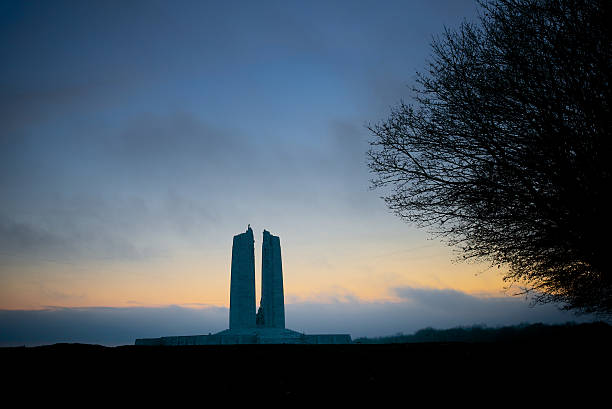 Dawn beaking, Canadian War Memorial, Vimy Ridge Vimy Ridge, France, November 11, 2014. The Canadian War Memorial silhouetted against the sunrise on Armistice Day. Designed by Walter Seymour Allward, the memorial was unveiled in 1936 to honour those Canadians who gave their life for their country in WW1. vimy memorial stock pictures, royalty-free photos & images