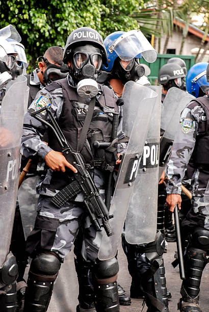 Riot police with shields and masks Tegucigalpa, Honduras - September 28, 2009: Riot police with anti-gas mask preparing to break up a demonstration for political crisis in Honduras, for the overthrow of President Manuel Zelaya. riot police stock pictures, royalty-free photos & images