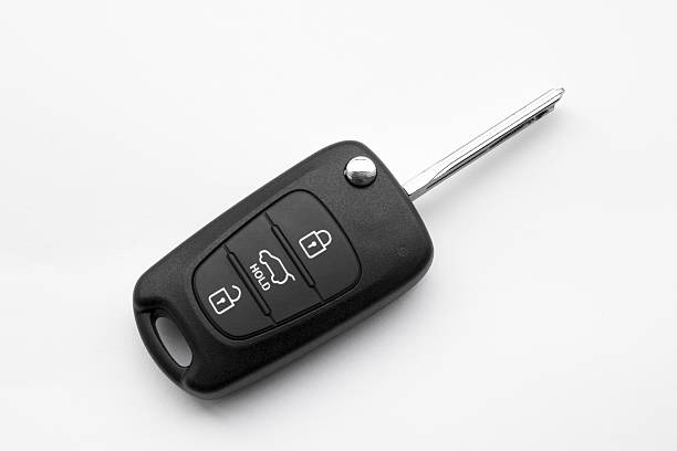 Remote entry car key on a white background A car key with remote on white background key ring stock pictures, royalty-free photos & images