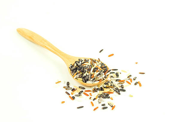 istock rice in wooden spoon isolated on white background 466083094