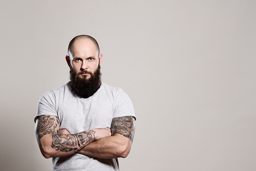 Bearded man with crossed arms - studio shot