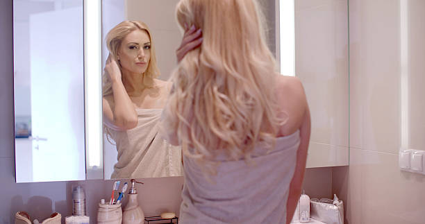 istock Woman Looking at Herself on the Bathroom Mirror 466084460