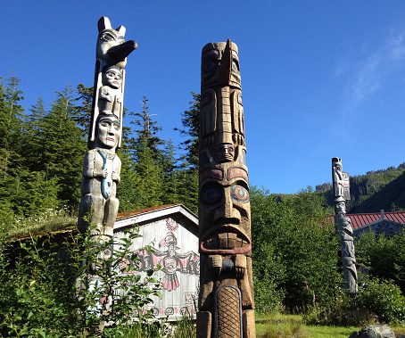 Three (3) totem poles in Ketchikan, Alaska.