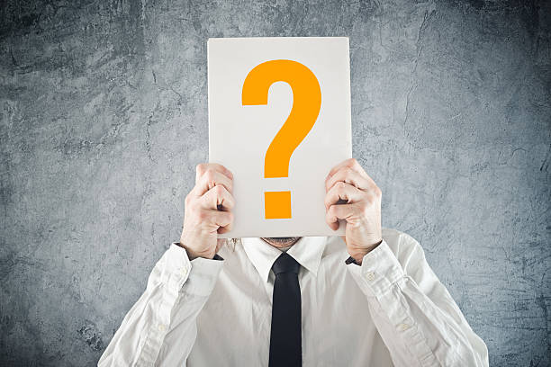 istock Businessman holding paper with printed question mark 466085431