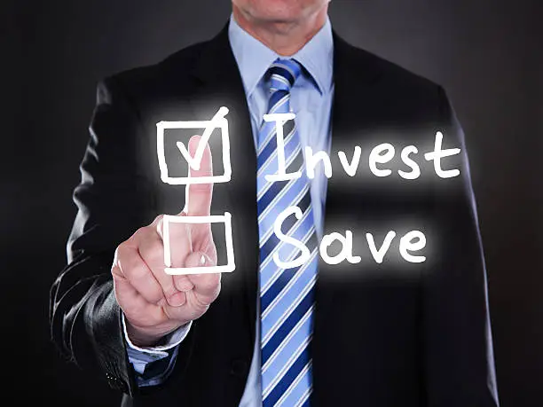 Photo of Businessman selecting invest option on the screen