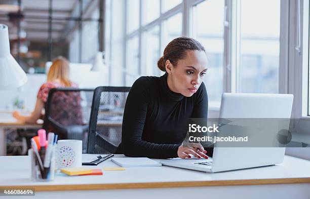 Young Business Executive Using Laptop Stock Photo - Download Image Now - Office, Concentration, Working
