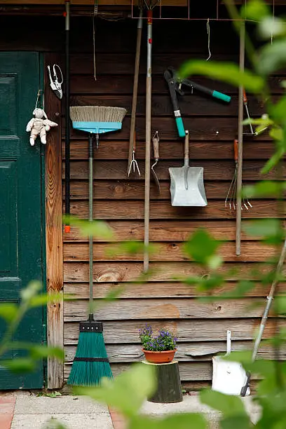 Gardening tools on wooden wall.