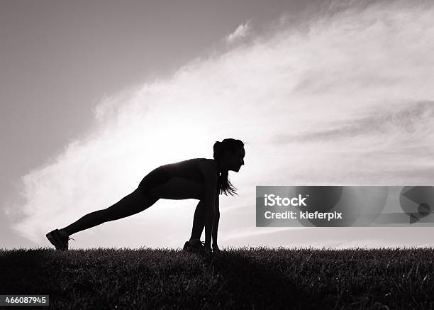 Woman Stretching Before Her Morning Run Stock Photo - Download Image Now - Black And White, Running, Active Lifestyle