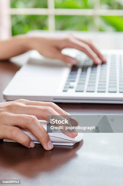 Hands Working On A Laptop With Wireless Mouse Stock Photo - Download Image Now - 2015, Adult, Adults Only