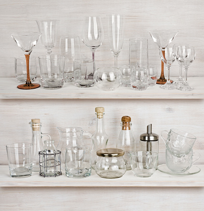 Various glassware collection on wooden shelves