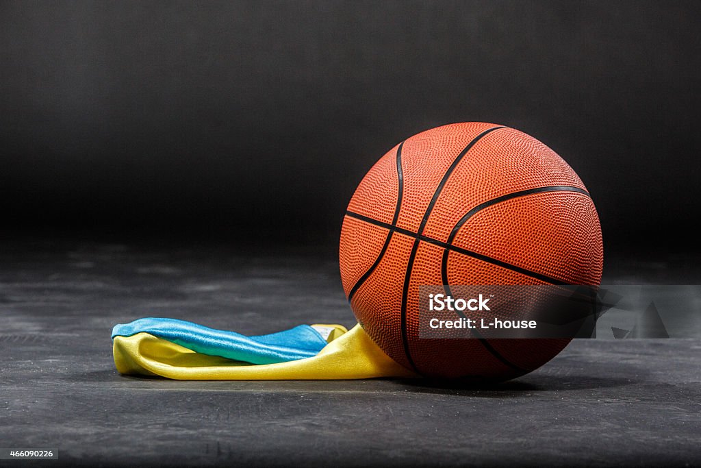 Basketball ball and flag Basketball ball lying on a black background 2015 Stock Photo