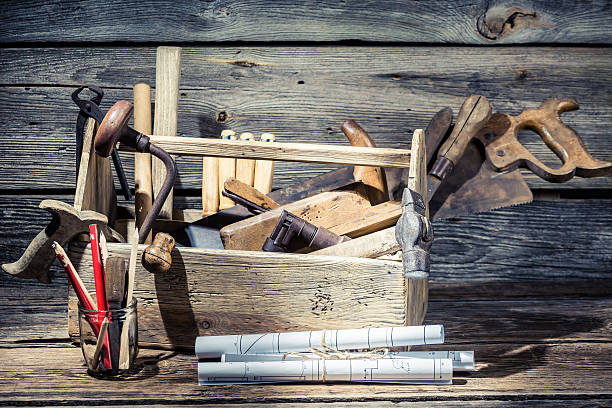istock Hammer, saw and paper scheme in the carpentry workshop 466090768