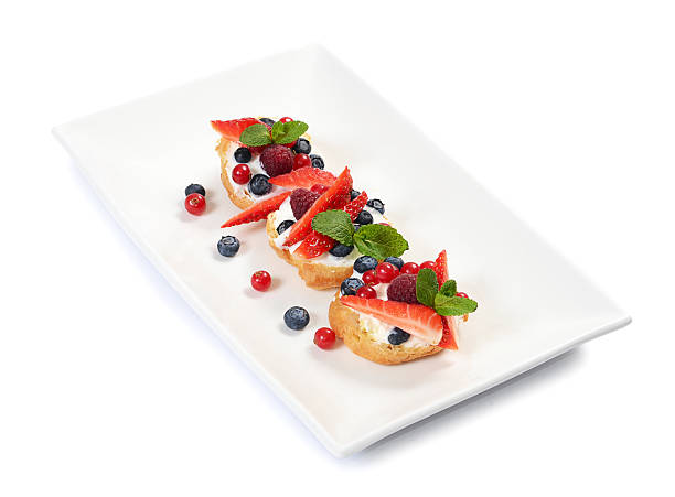 istock Profiteroles with berries currant , strawberries and blueberries 466092130