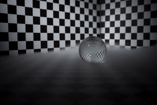 Crystal ball on a checkered background and in a fog.