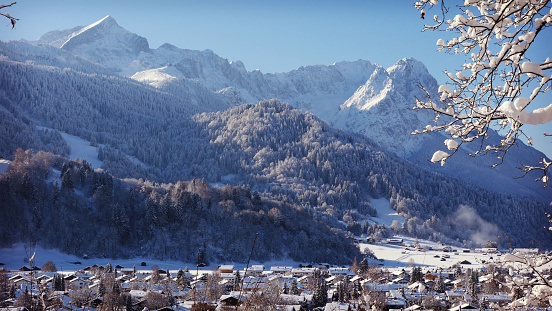 Wonderful panorama of Garmisch-Partenkirchen and the German Alps. Here you can see the Wetterstein Mountains with the Alpspitze on the left and Germany's highest mountain Zugspitze on the right behind the Waxensteine.