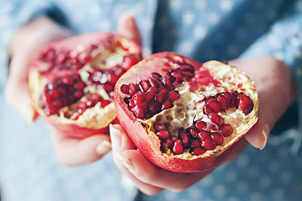 woman holding pomegranate