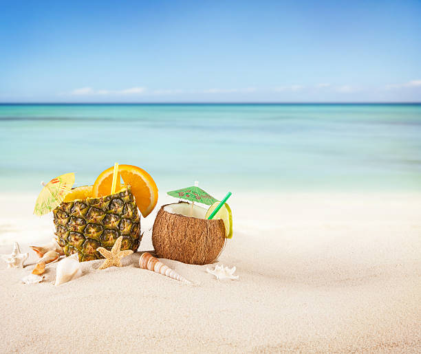 istock Pineapple and coconut drinks in the sand at the beach 466097664
