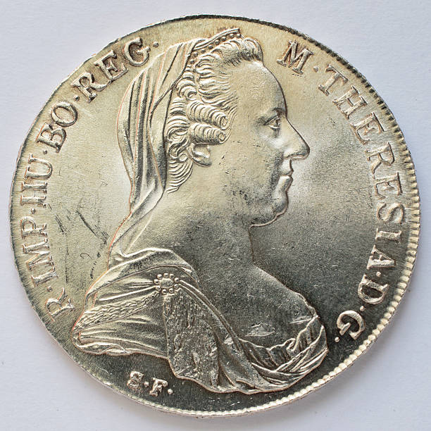 This Austrian coin, the Maria Theresien Taler (MTT), was first minted in 1741, and from that time forward was widely adopted as silver bullion in world trade. It has a purity of 0.833, as against English sterling silver which has a purity of 0.925. Maria Theresa (Maria Theresia), for whom the coin is named, was Empress of Austria, Hungary, and Bohemia from 1740 to 1780, and the silver thaler / taler coin is always dated 1780. This photo shows the obverse / front of the coin, the head of the Empress. The letters S.F. show that this example was struck after 1850.  Thaler is the root word from which 'dollar' originated.