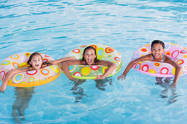 istock Girls playing in swimming pool. 466099645