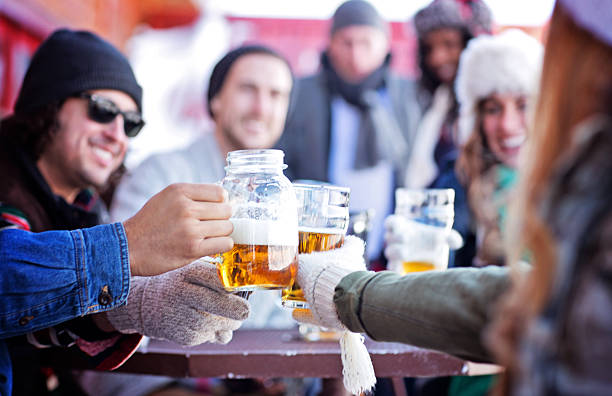 Friends Having Good Times After Skiing A group of friends having beer after skiing. Note to inspector: The model releases are in the width of 1275 pixel and all fields are legible. Please zoom in 100%. apres ski stock pictures, royalty-free photos & images