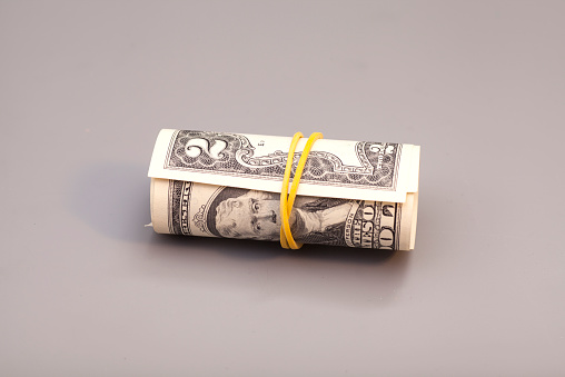 two dollars of roll isolated on gray background