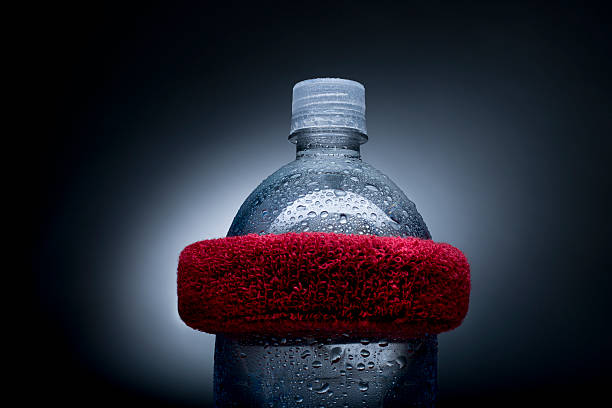 Water bottle with head sweat band, conceptual Water bottle with red head sweat band, conceptual sweat band stock pictures, royalty-free photos & images