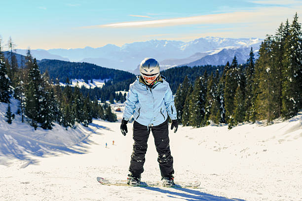 Female Snowboarder learning stock photo