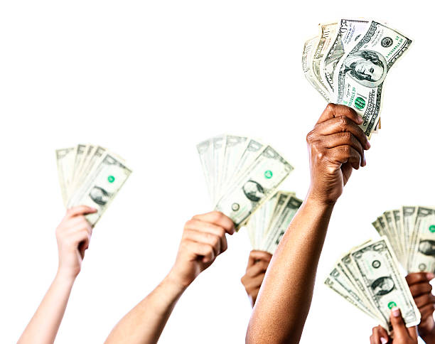 istock Six eager hands offering bundles of banknotes 466104299