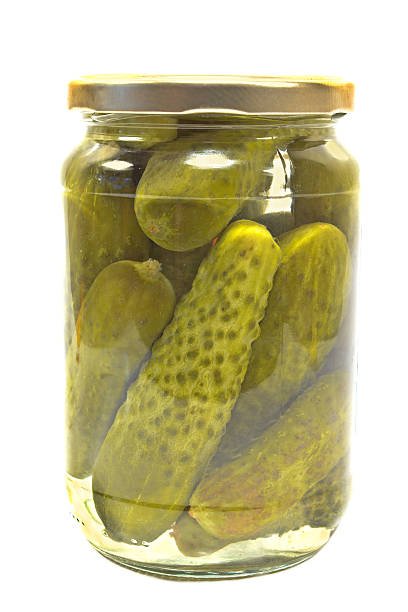istock Pickled cucumbers in jar isolated on white 466104370
